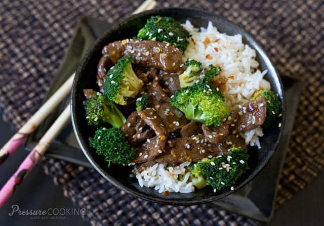 A bowl of food with rice and broccoli, with Beef and Sauce