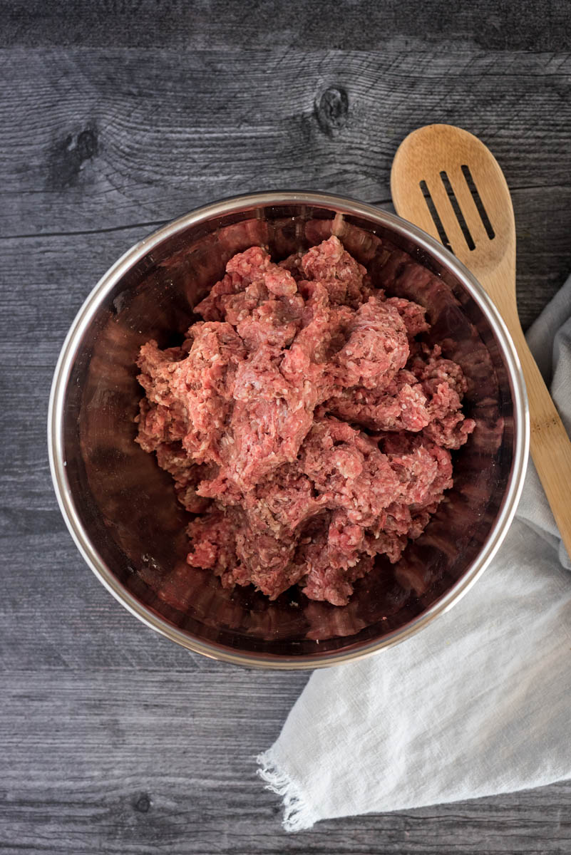 A bowl of ground beef being prepped for Instant Pot chili