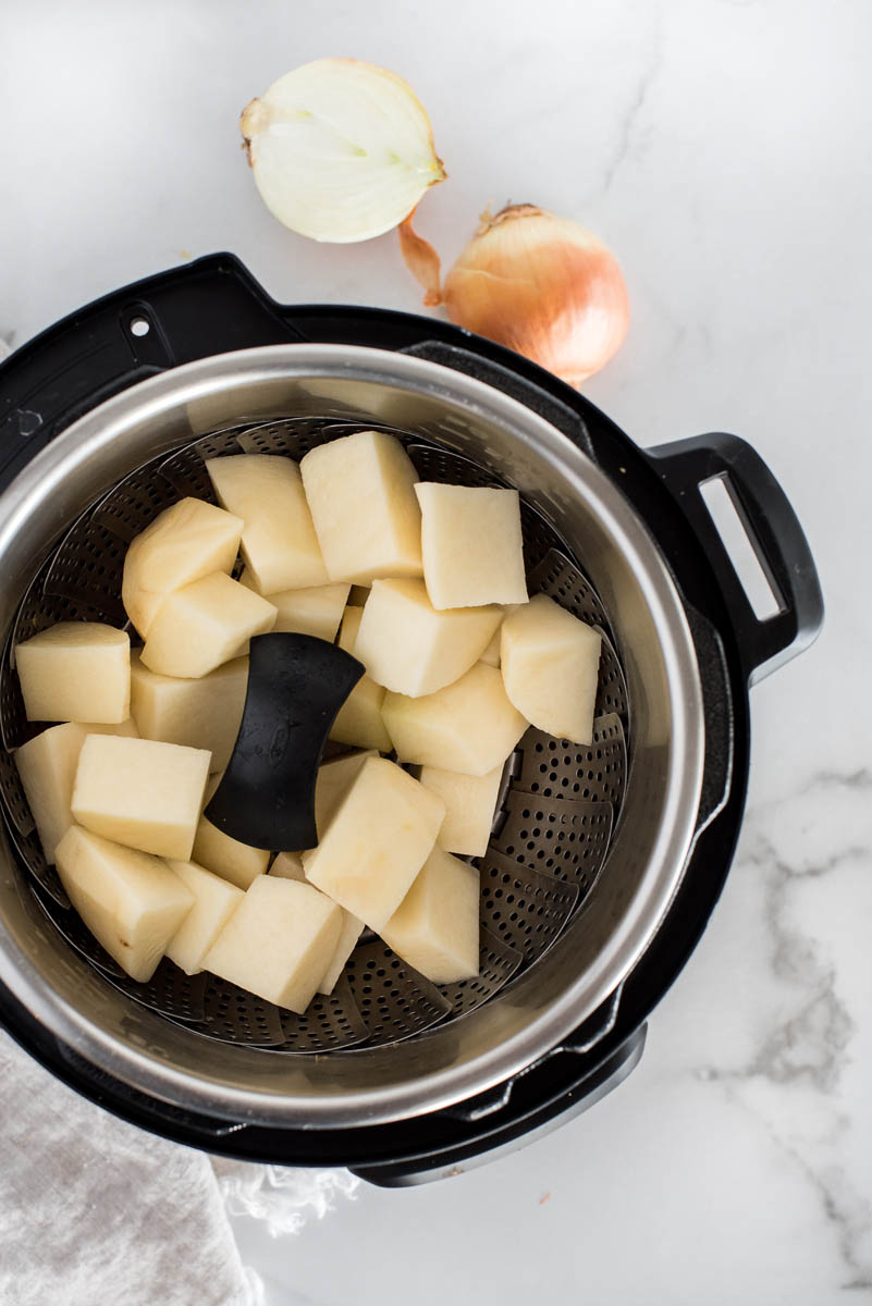 overhead of cubed potatoes in a pressure cooker