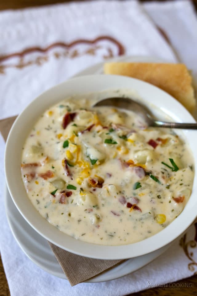 chunky potato cheese soup garnished with bacon, scallions, and corn niblets