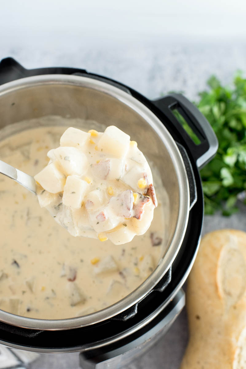 ladeling chunky potato soup from an instant pot