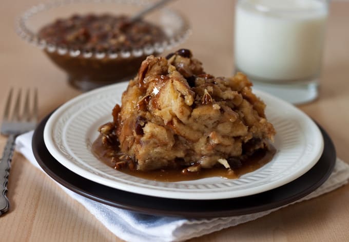 Pressure Cooker (Instant Pot) Cinnamon Raisin Bread Pudding with Caramel Pecan Sauce on a white plate