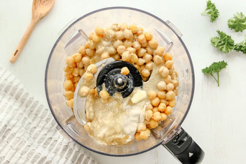 food processor with hummus being blended