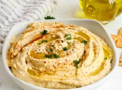 bowl of instant pot hummus with herbs and spices on top