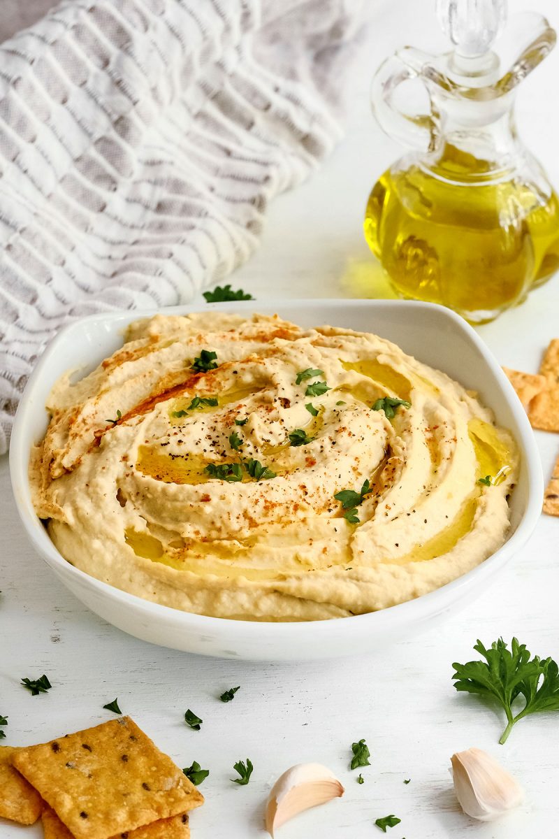bowl of instant pot hummus with herbs and spices on top