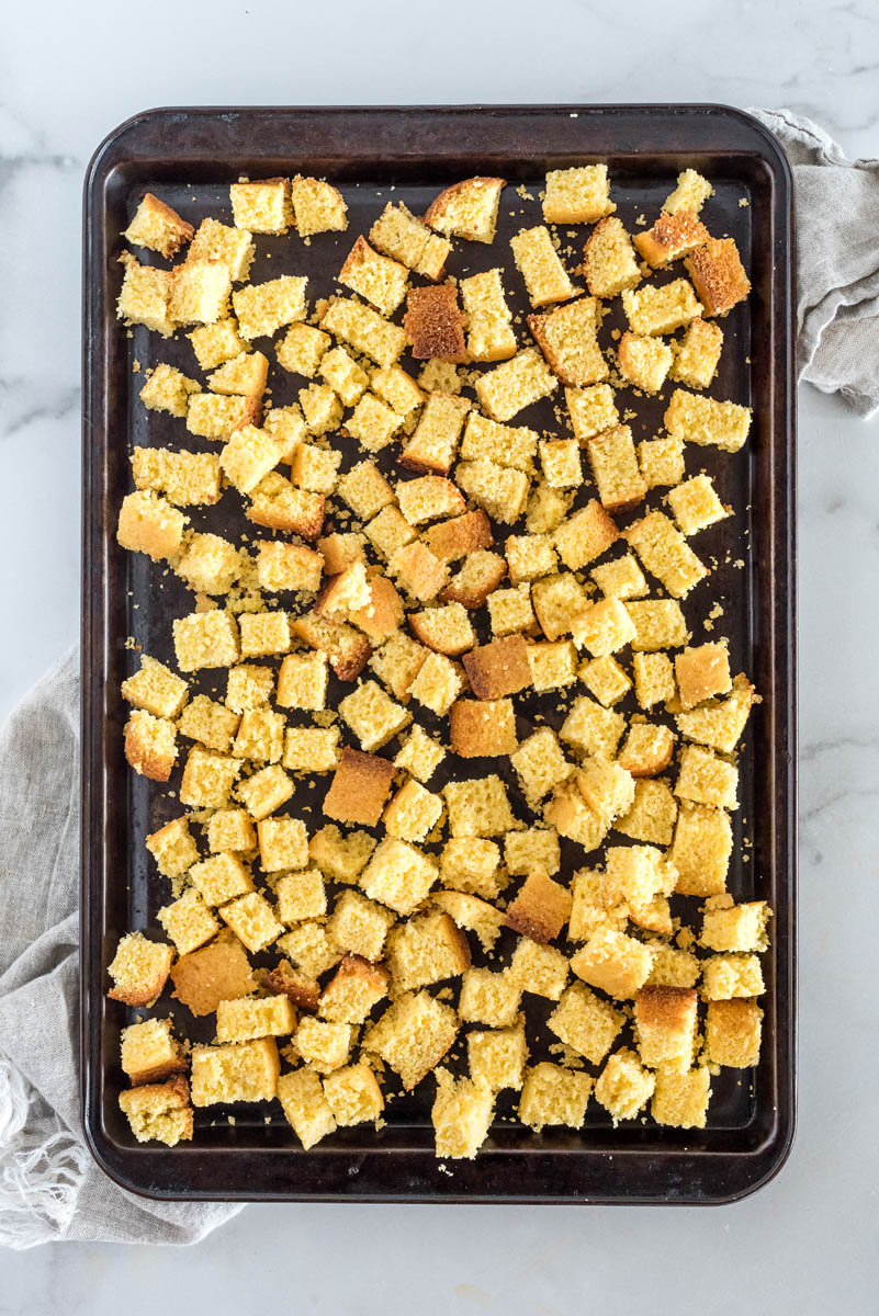 Cornbread cubed and drying on a baking sheet to be used in cornbread dressing.