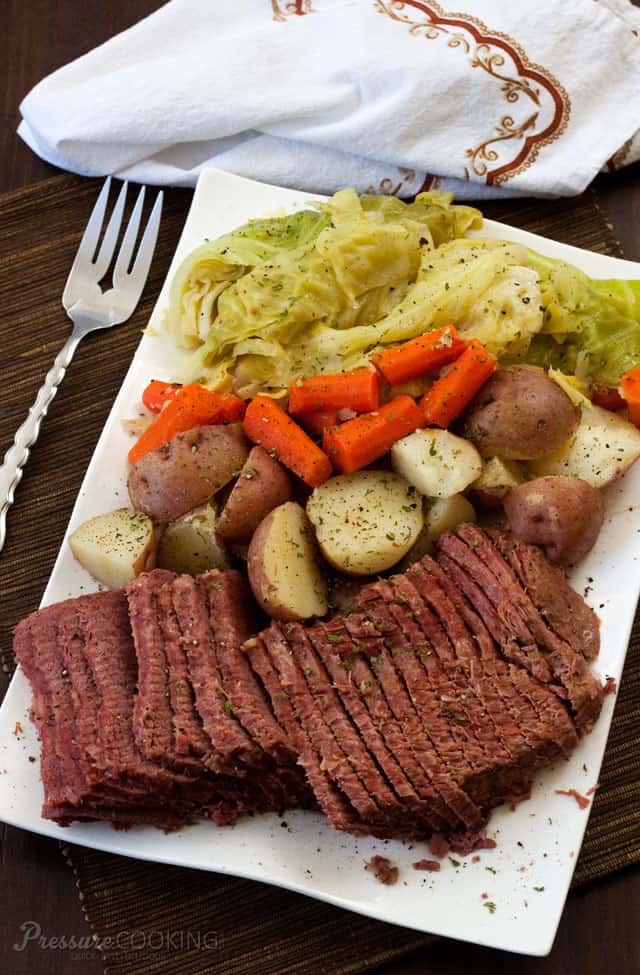 Pressure Cooker Corned Beef and Cabbage served on a white plate and ready to eat