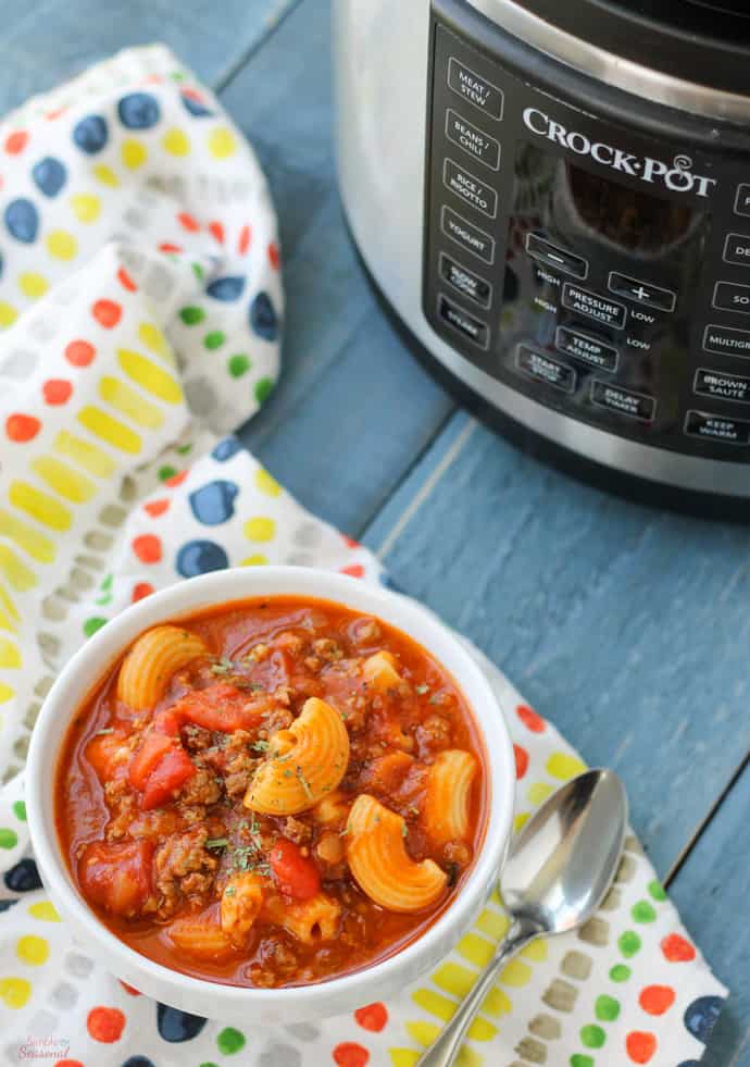 A bowl of American Goulash in a white bowl in front of an Instant Pot