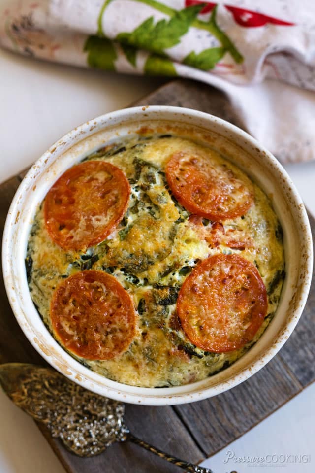 overhead image of a crustless quiche with spinach and tomatoes, made in a pressure cooker