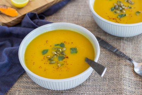 Pressure Cooker Curried Carrot Soup in a white bowl with a spoon