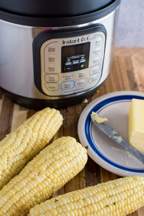 Corn on the Cob, soft butter, and an Instant Pot in the background