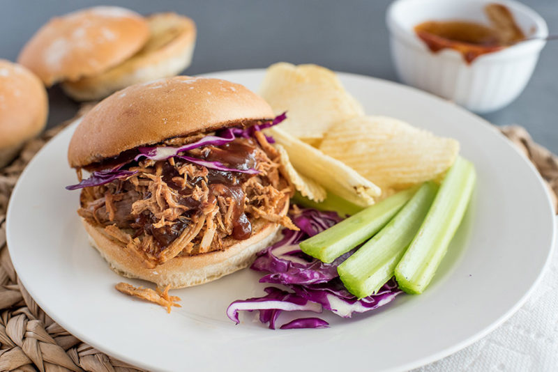 Instant Pot Pulled Pork sandwich, with cabbage, celery, and potato chips