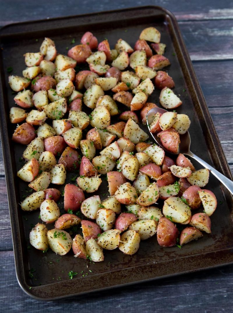 A sheet pan full of prepared Instant Pot / Pressure Cooker Garlic Herb Roasted Red Potatoes