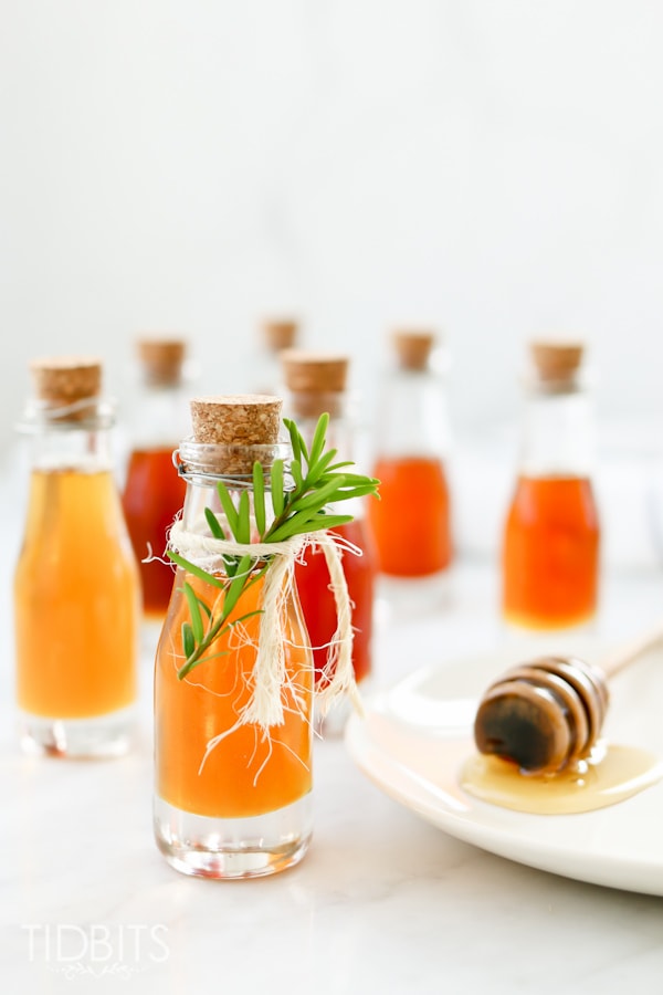 Glass bottles with flavor infused honey made in a pressure cooker