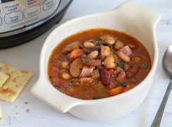 Instant Pot 15 Bean Soup in a bowl with crackers and an Instant Pot