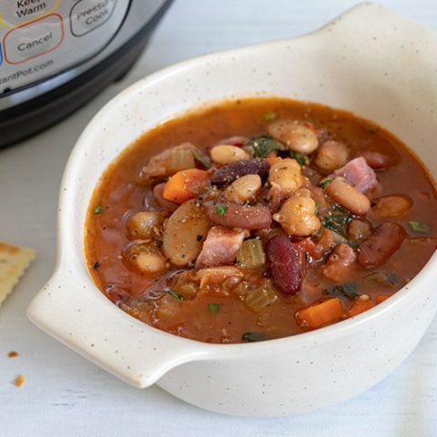 Instant Pot 15 Bean Soup in a bowl with crackers and an Instant Pot