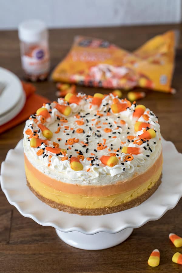 Decorating a luscious, easy-to-make Pressure Cooker Candy Corn Cheesecake sweetened with honey.&nbsp;