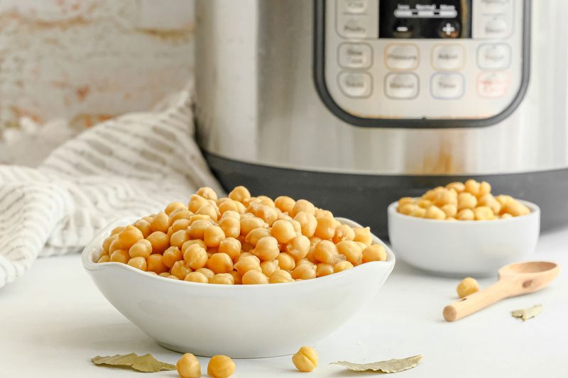 bowl of cooked chickpeas in front of an instant pot pressure cooker