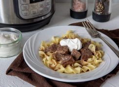 Sirloin-Tips-in-Gravy over noodles served on a white plate