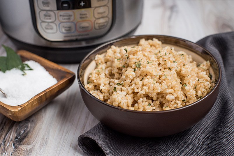Instant Pot Brown Rice prepared with a dish of salt and an Instant Pot in the background