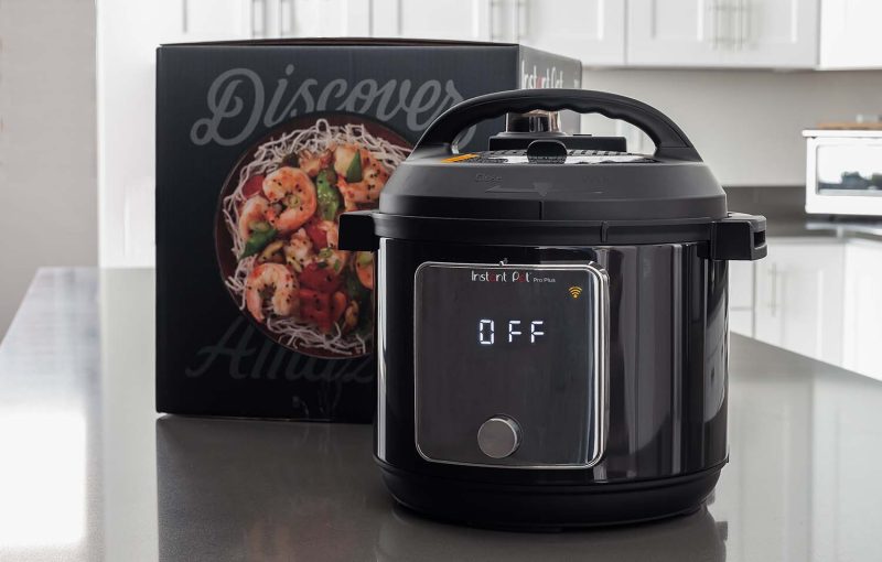 Instant Pot Pro Plus on a kitchen counter with the box in the background.