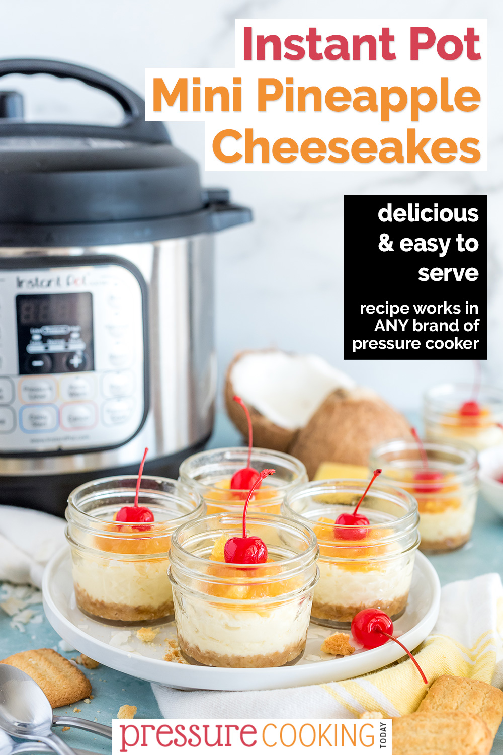 A Pinterest image reading "Instant Pot Mini Pineapple Cheesecakes" featuring a 45 degree shot of four mini mason jars filled with Instant Pot Coconut Cheesecakes, with a sweet pineapple topping and a maraschino cherry on top, with an Instant Pot, coconut, and pineapple visible in the background via @PressureCook2da