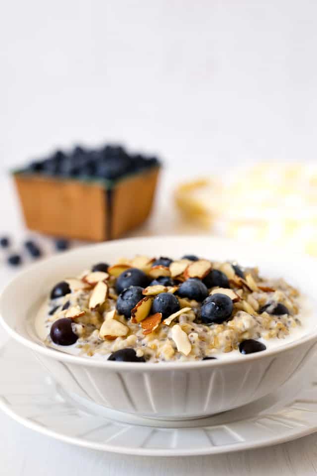 My Lemon Blueberry Steel Cut Oats are creamy, lightly sweet, flavored with lemon, studded with blueberries and chia seeds, and topped with sliced almonds.