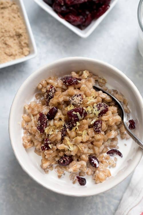 Lemon-Cranberry-Farro in a white bowl with a spoon