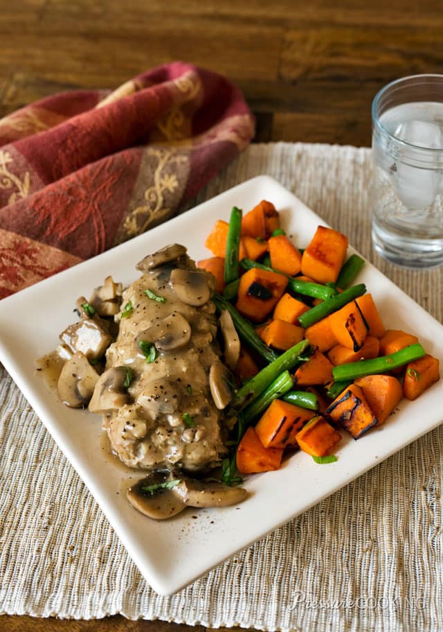 Pressure Cooker Mini Cheese Stuffed Turkey Meatloaves filled with a creamy garlic and herb cheese and smothered with a flavorful mushroom gravy on a white plate