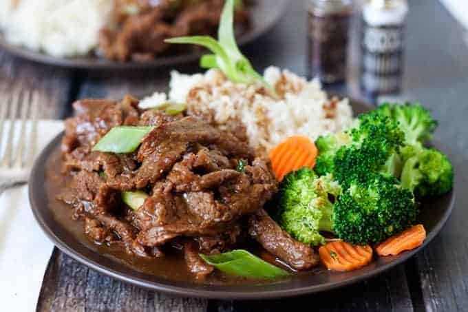 Pressure Cooker (Instant Pot) Mongolian Beef Recipe served on a plate with broccoli and carrots and rice
