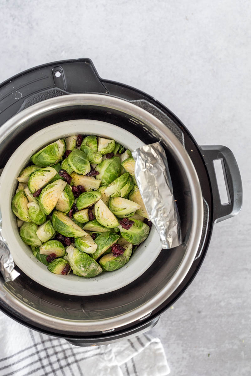 an overhead shot of an Instant Pot filled with brussels sprouts, ready to cook