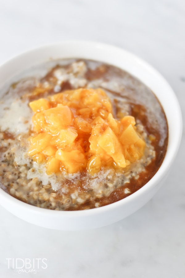 Steel Cut Oats served in a white bowl with peaches and cream