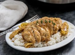 Pressure Cooker (Instant Pot) Artichoke Chicken over rice on a white plate with fork