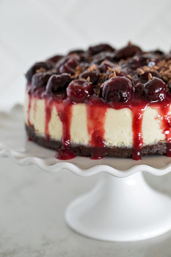 A decadent Pressure Cooker Black Forest Cheesecake with a fudgy brownie bottom topped with a creamy smooth cheesecake and served with a sweet, tart cherry compote. 
