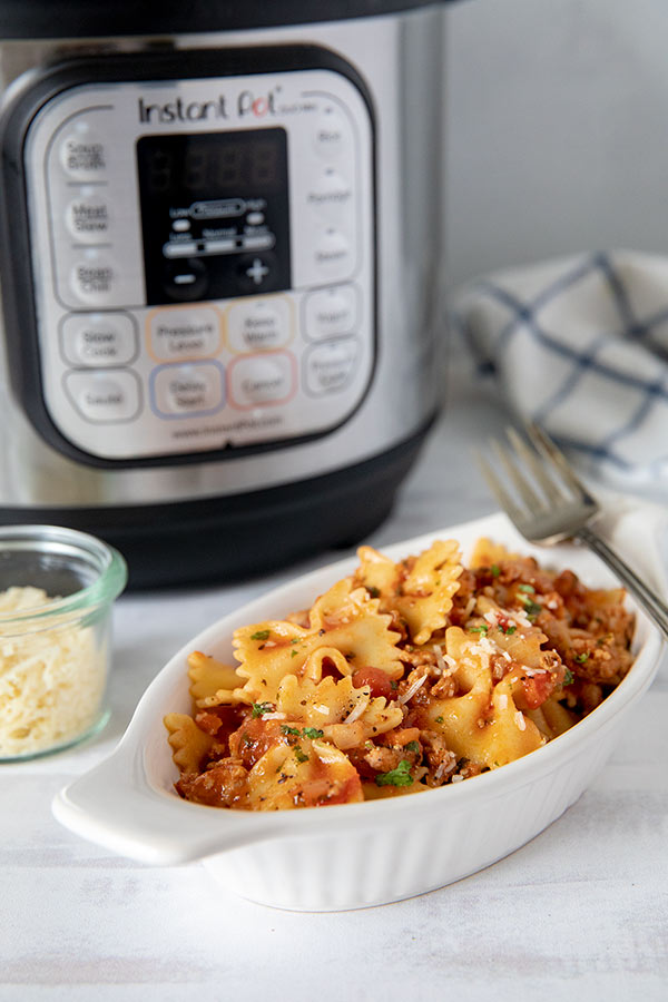 Pressure-Cooker-Bow-Tie-Pasta in front of an Instant Pot