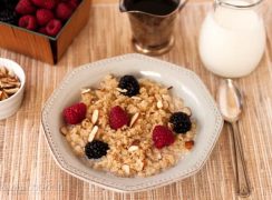 Pressure Cooker (Instant Pot) Breakfast Quinoa in a white bowl with blackberries and raspberries on the top.