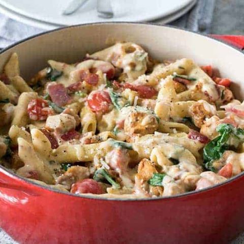 Pressure-Cooker-Chicken-Bacon-Penne-Pasta-In-Garlic-Cream-Sauce served in a red bowl.
