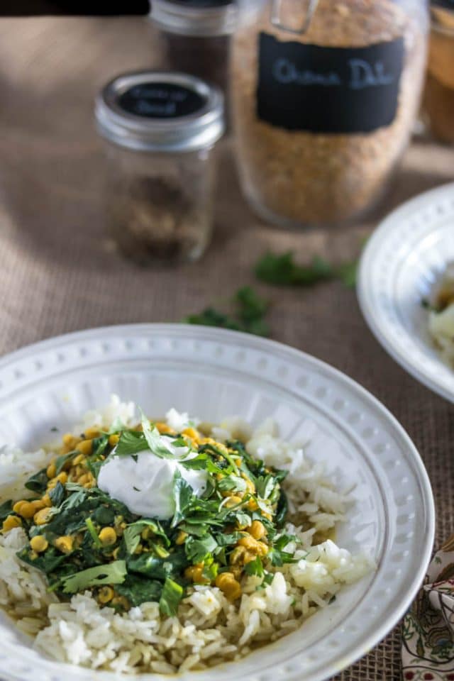 white bowl of Pressure Cooker Dal With Spinach served over white rice