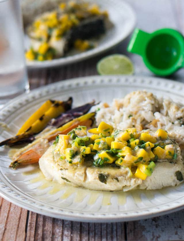 white dinner plate of Thai-Style Pressure Cooker Fish with coconut rice and mango salsa