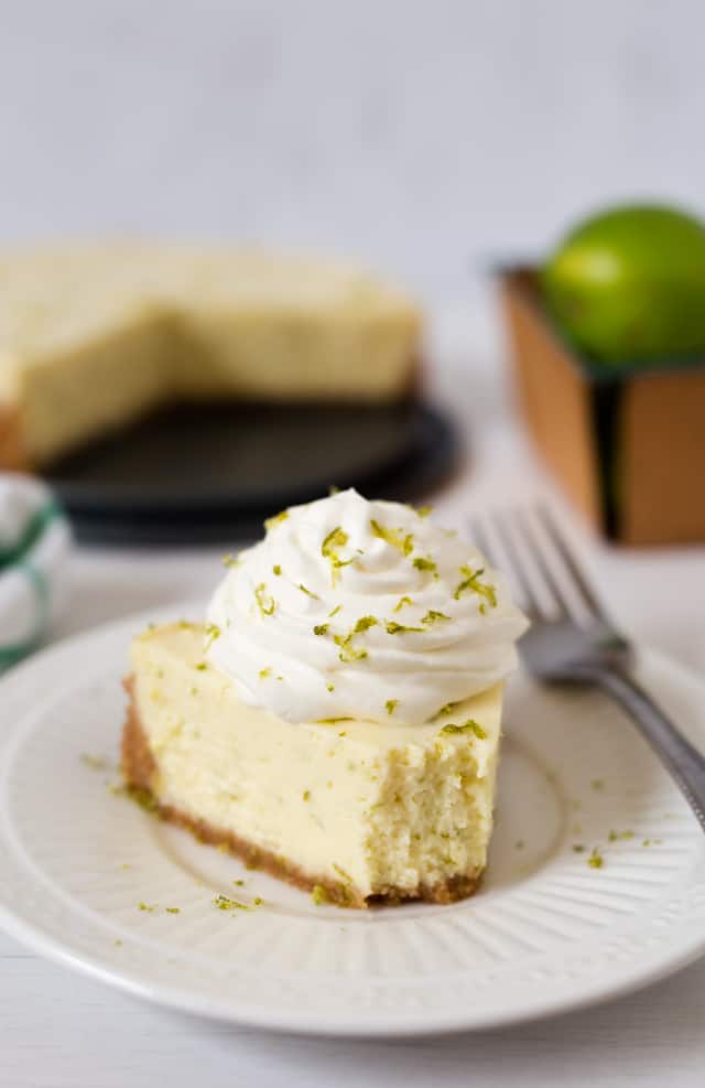 A tart, creamy key lime pie with a graham cracker crust \"baked\" in the pressure cooker, then served topped with some lightly sweetened whipped cream. 