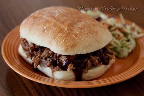Easy Pressure (Instant Pot) Cooker Pulled Pork Sandwich on a roll with coleslaw