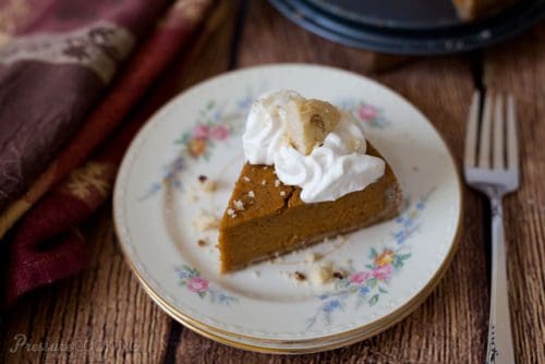Pressure Cooker (Instant Pot) Pumpkin Pie with whipped cream on a white plate