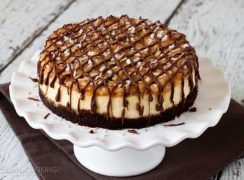 Pressure Cooker (Instant Pot) Samoa Cheesecake on a white cake stand