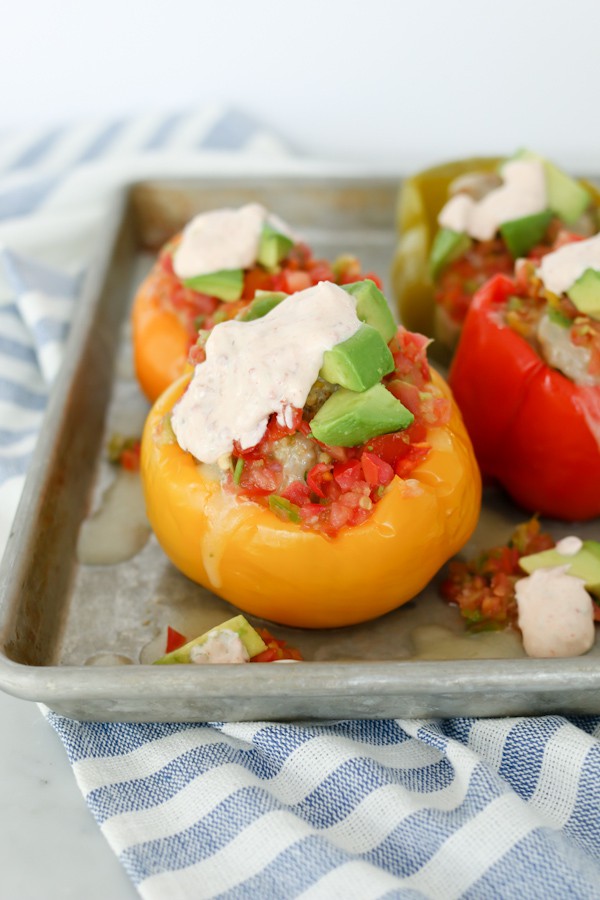 Pressure Cooker Mexican Stuffed Bell Peppers with Chipotle Lime Sauce on a sheet pan