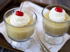 two dessert cups of Pressure Cooker (Instant Pot) Tapioca Pudding topped with whipped cream and a cherry
