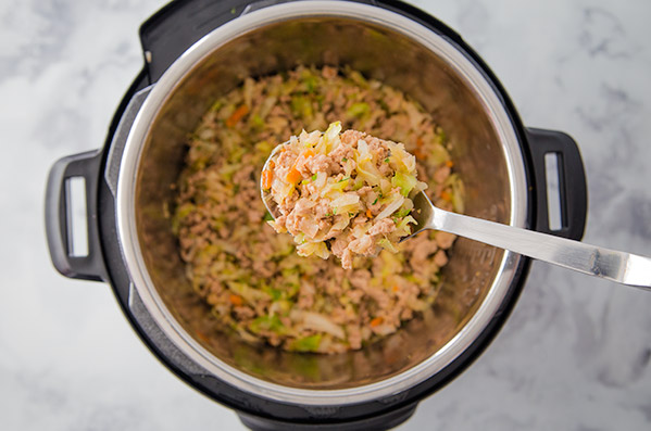 Pressure Cooker Egg Roll in a Bowl recipe, with a spoonful out and ready to serve
