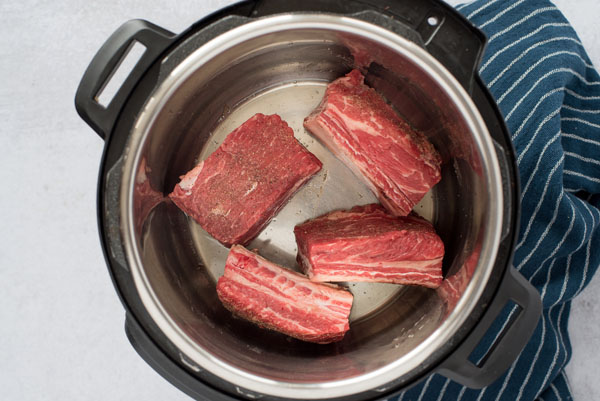 Browning beef short ribs in an Instant Pot.