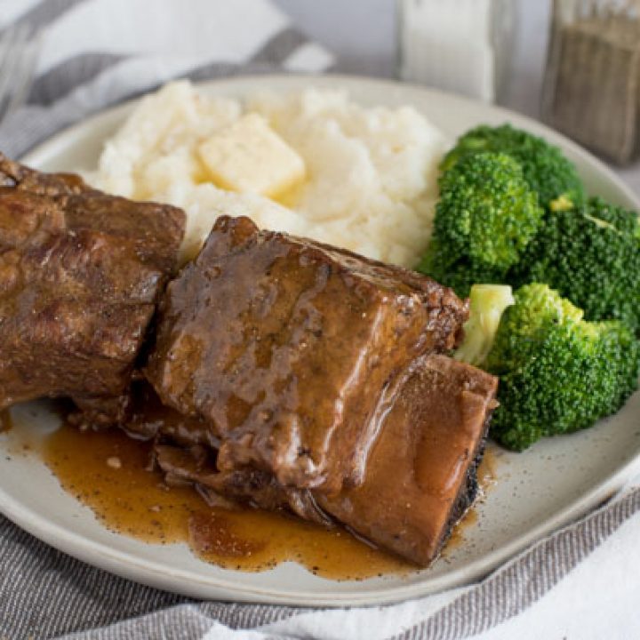 Instant Pot Short Ribs plated with broccoli and mashed potatoes.