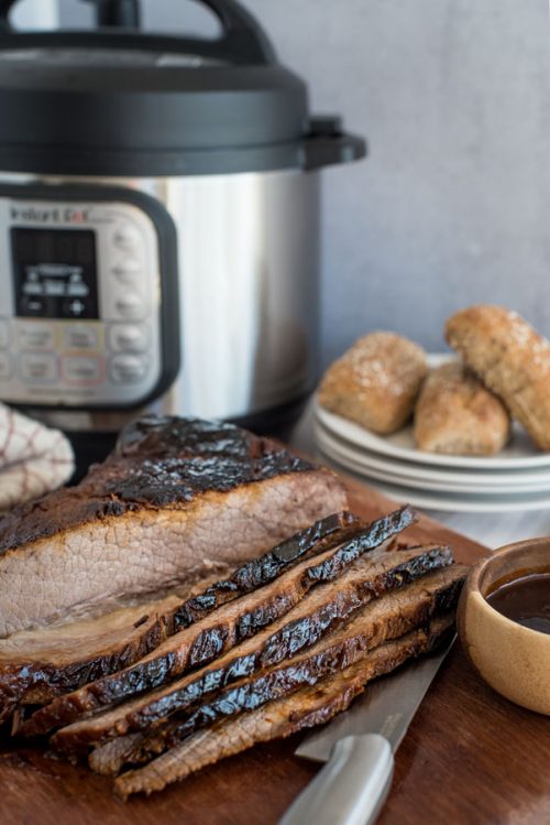 BBQ beef brisket sliced in front of an Instant Pot.