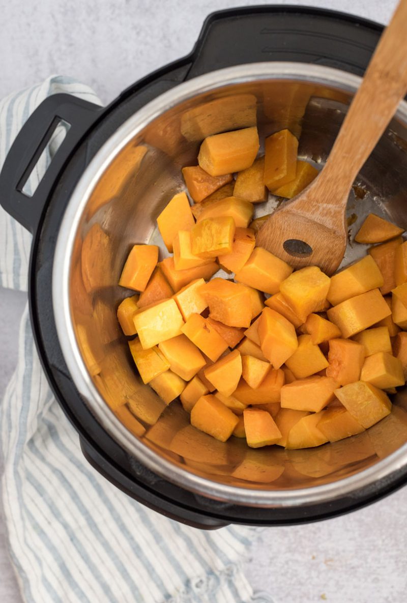 an overhead shot showing cubed butternut squash in the bottom of an Instant Pot